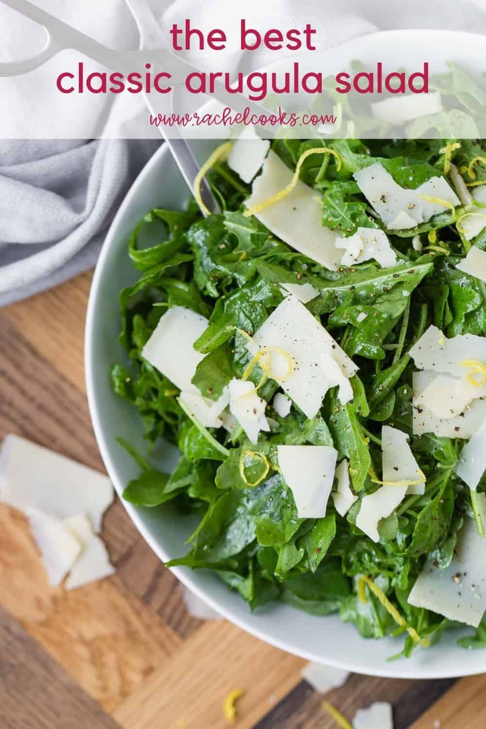 Overhead view of an arugula salad with a text overlay that reads "the best classic arugula salad, rachelcooks.com"