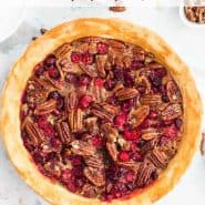 Overhead view of pie, text overlay reads "pecan cranberry pie, rachelcooks.com"