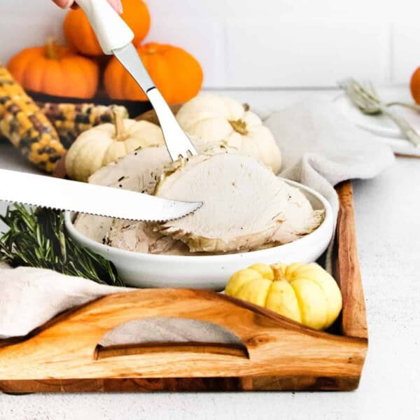 Sliced turkey breast with a knife and fork.