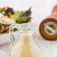 Salad dressing in a jar, text overlay reads "creamy maple dressing with black pepper."