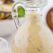 Salad dressing in a jar, text overlay reads "creamy maple dressing with black pepper."