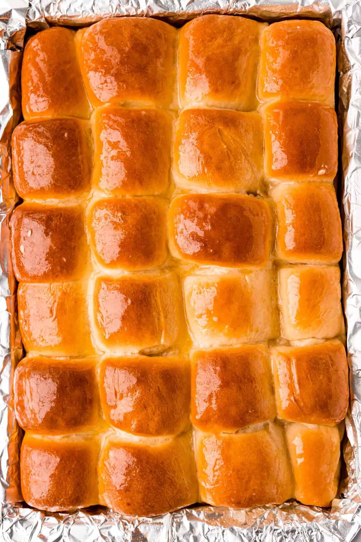 24 baked rolls in a pan.