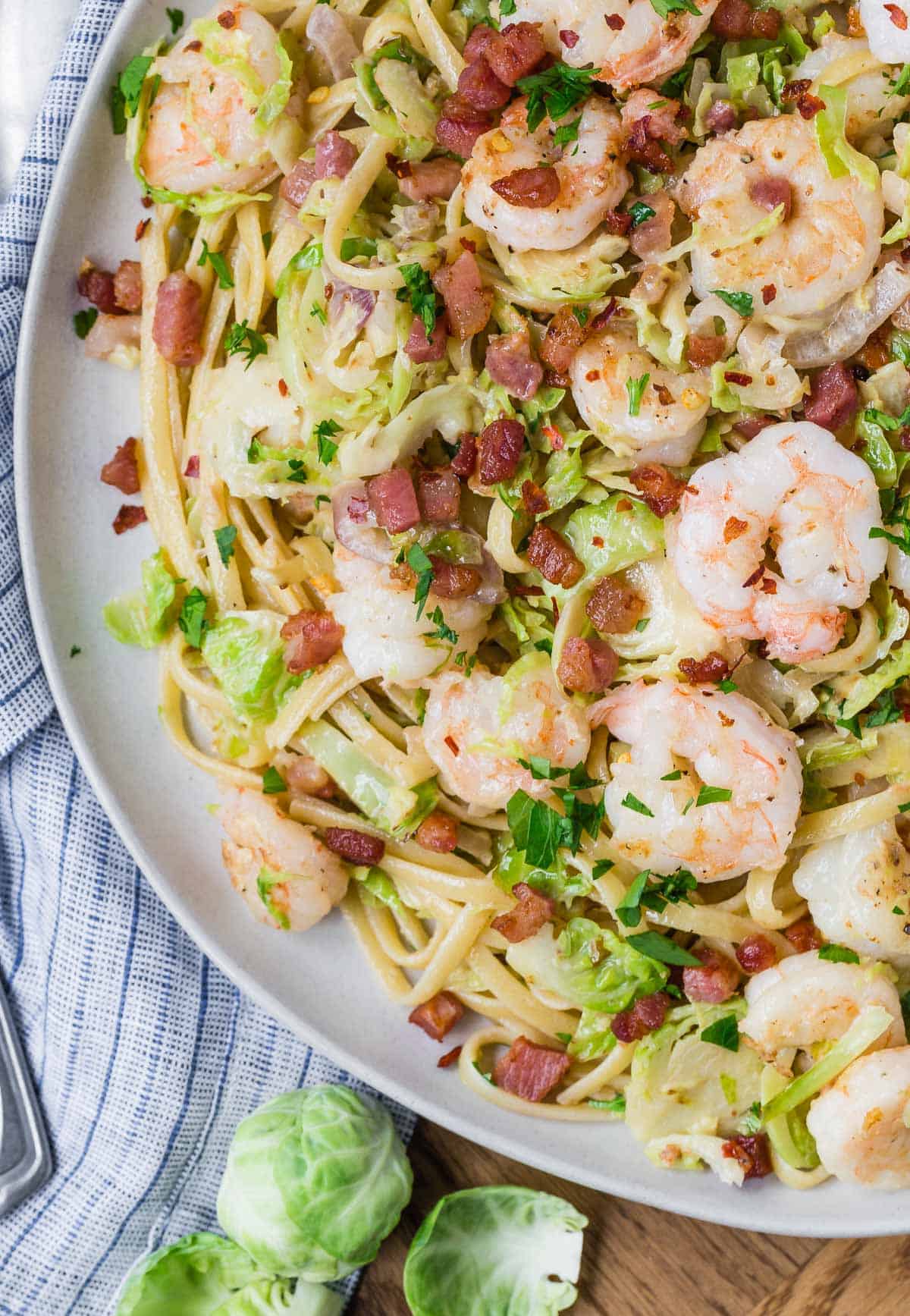 Close up overhead view of pasta with shrimp and pancetta.