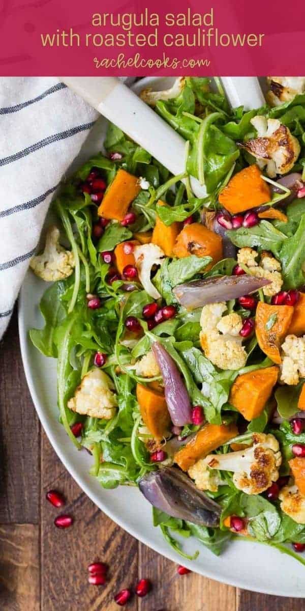 Colorful salad with text overlay that reads "arugula salad with roasted cauliflower, rachelcooks.com"