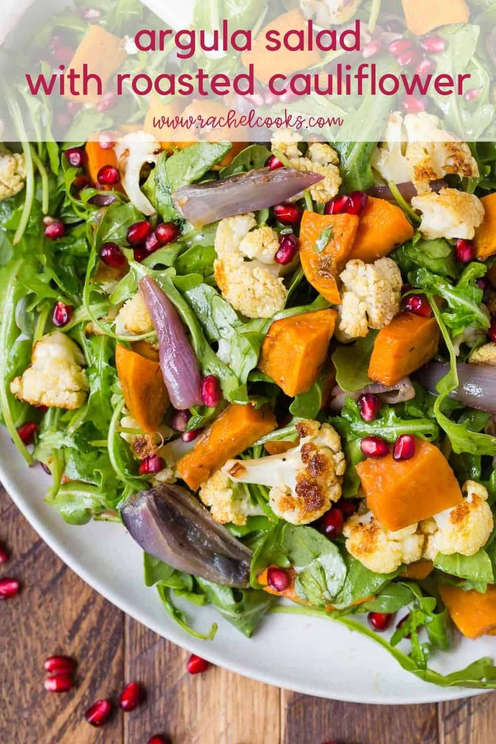 Colorful salad with text overlay that reads "arugula salad with roasted cauliflower, rachelcooks.com"