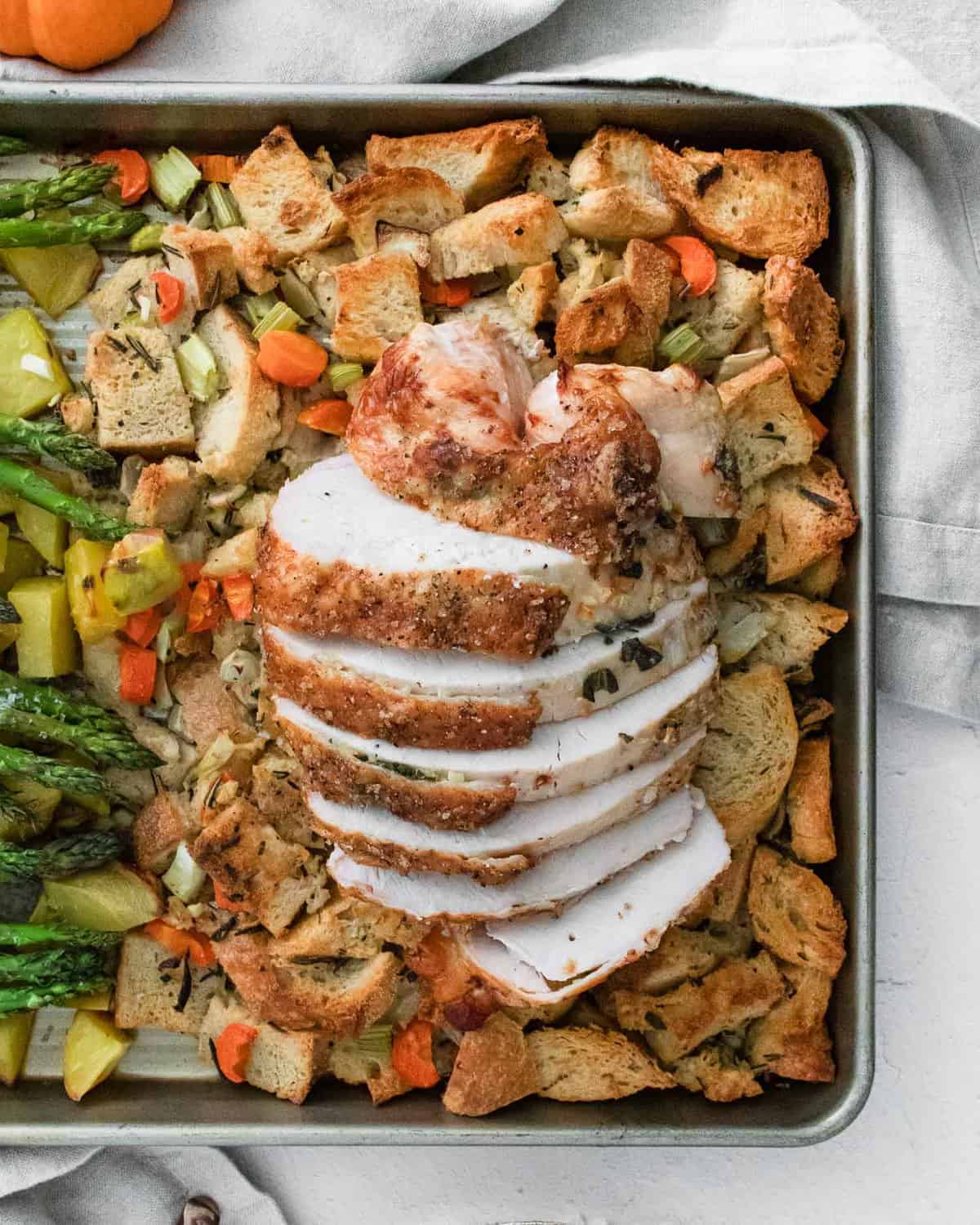 Turkey breast placed on top of stuffing.
