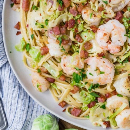Overhead view of pasta with shrimp and brussels sprouts.