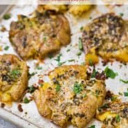 Potatoes on a sheet pan, text overlay reads "garlic parmesan smashed potatoes"