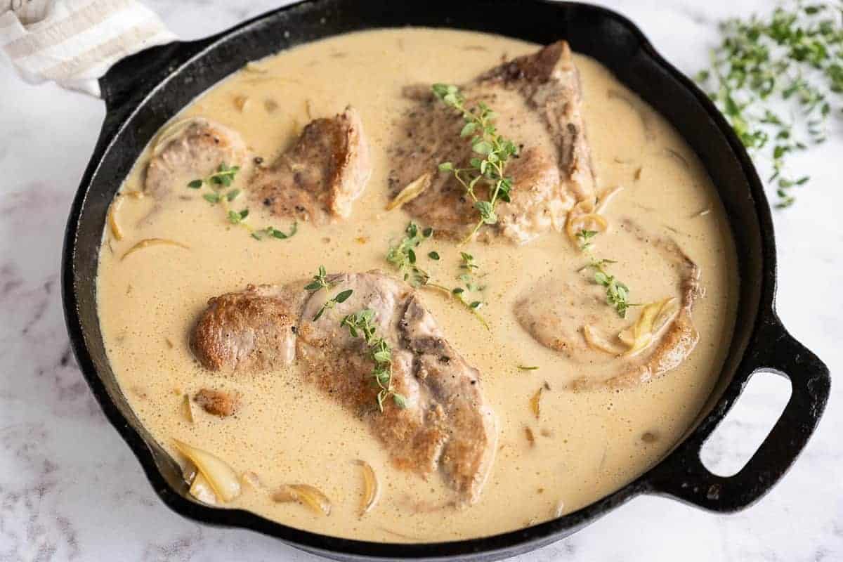 Pork in creamy gravy, topped with fresh thyme.