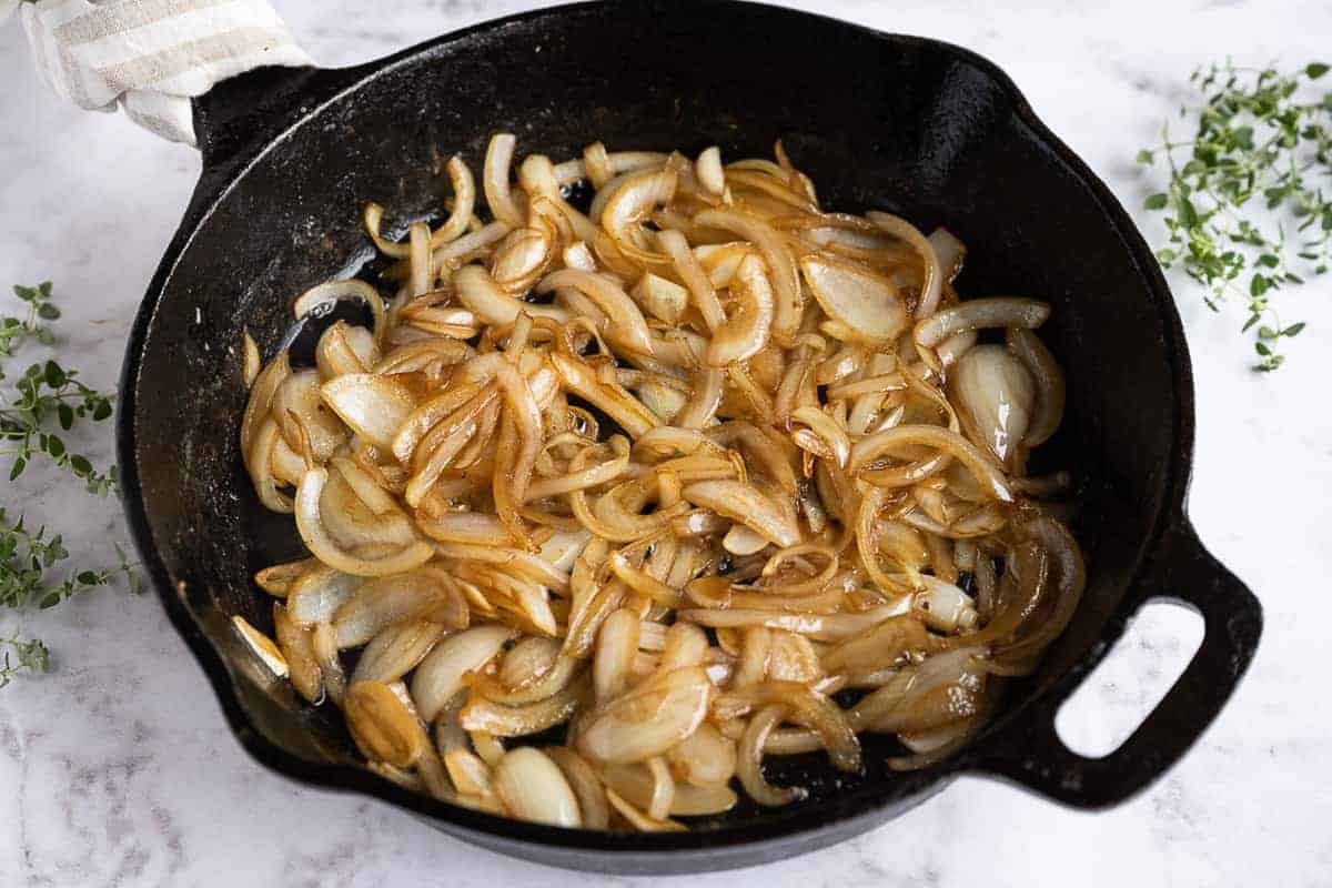 Cooked onions in a cast iron skillet.