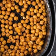 Chickpeas in an air fryer, text overlay reads "air fryer crispy chickpeas, rachelcooks.com"