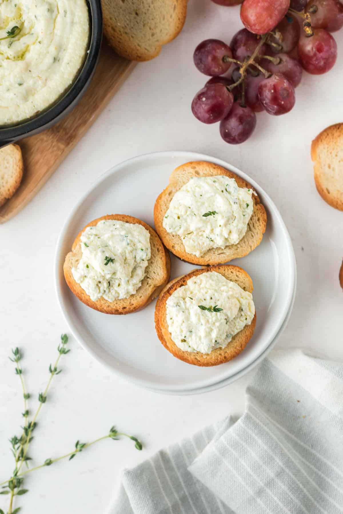 Goat cheese spread on small crostini.