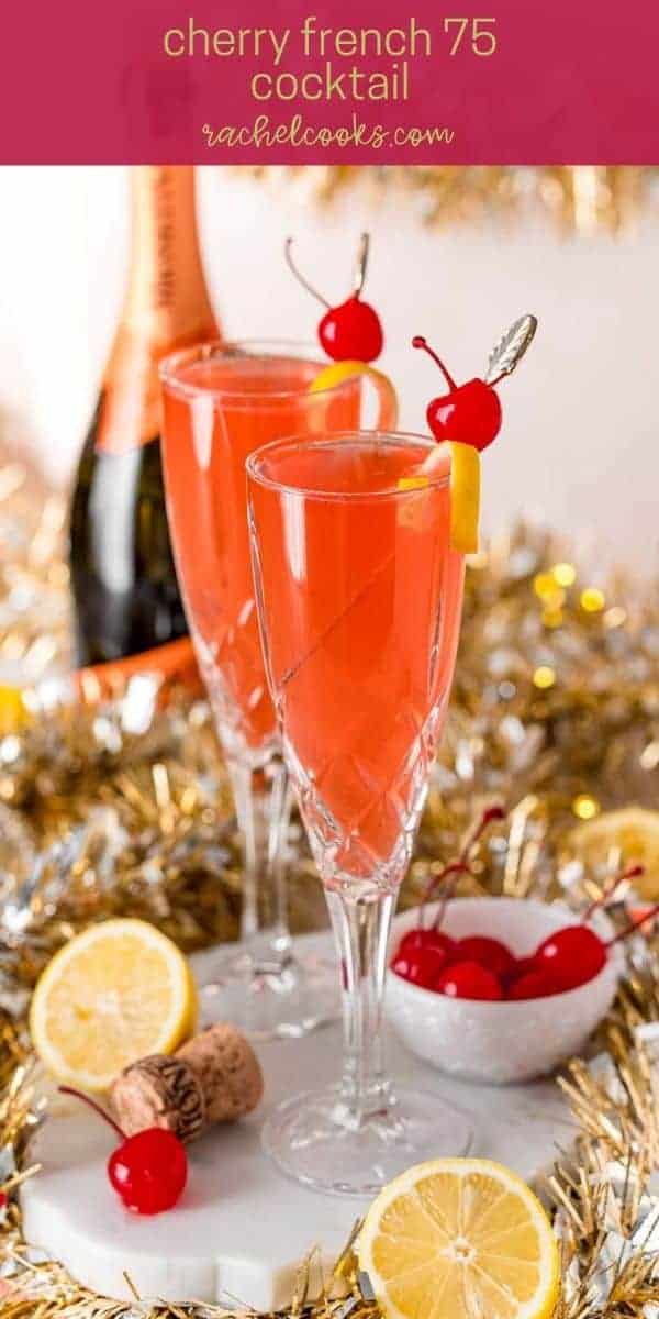 Light red drink garnished with lemon and a cherry. Text overlay reads, "cherry french 75 cocktail, rachelcooks.com"