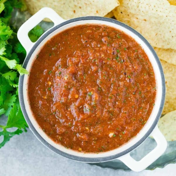 Overhead view of salsa in a white bowl with two handles.