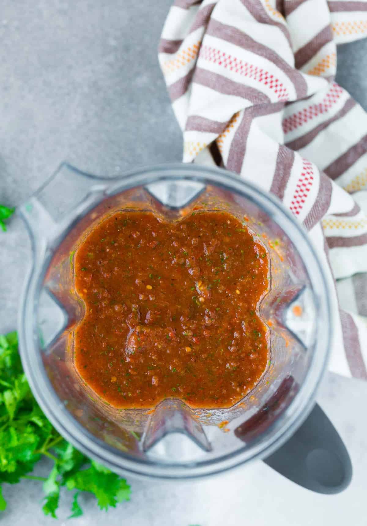 Overhead view of homemade salsa in a blender.