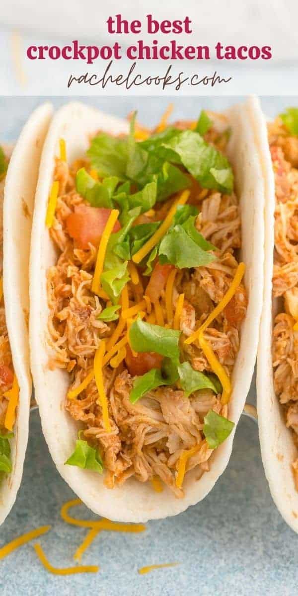 Shredded chicken on a tortilla with cheese, lettuce, and tomatoes. Text overlay reads "the best crockpot chicken tacos"