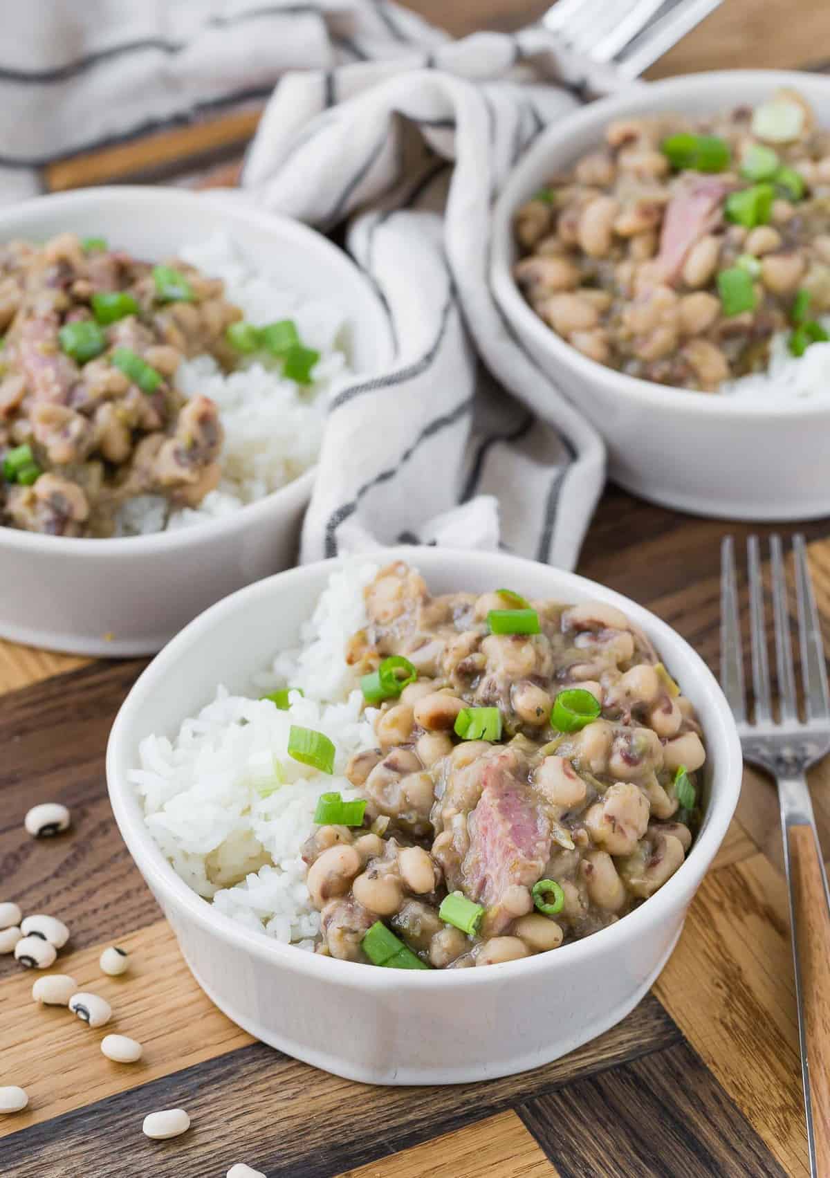 Three small white bowls of Hoppin' John. 