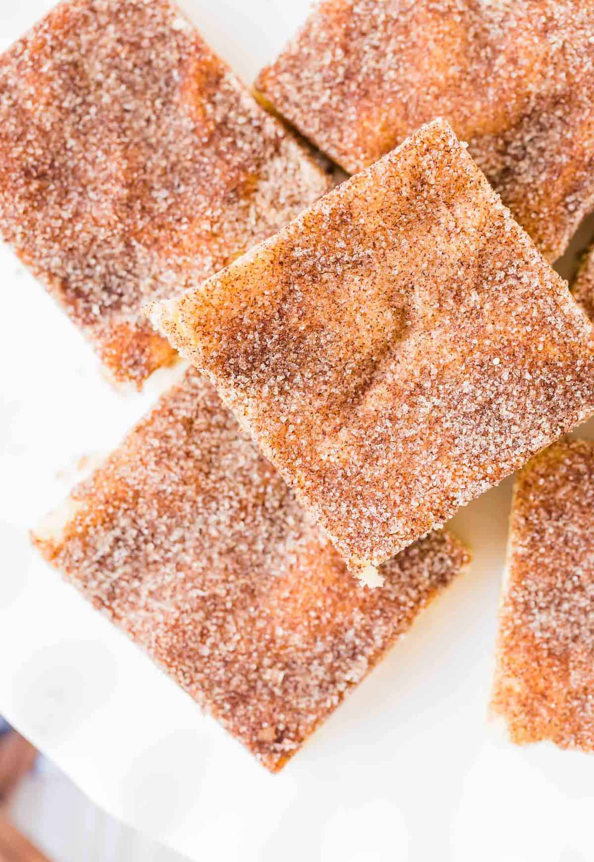 Overhead view of snickerdoodle cookie bars on a white plate.