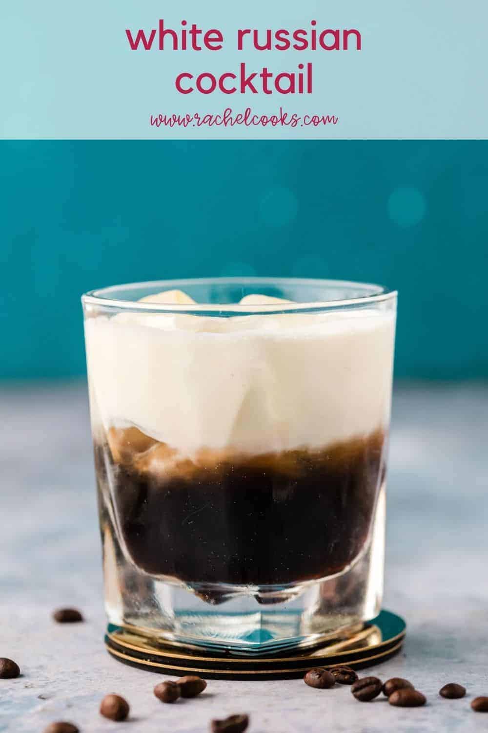 A short clear glass with a layered dark brown and white drink. Text overlay reads "white russian cocktail, rachelcooks.com"
