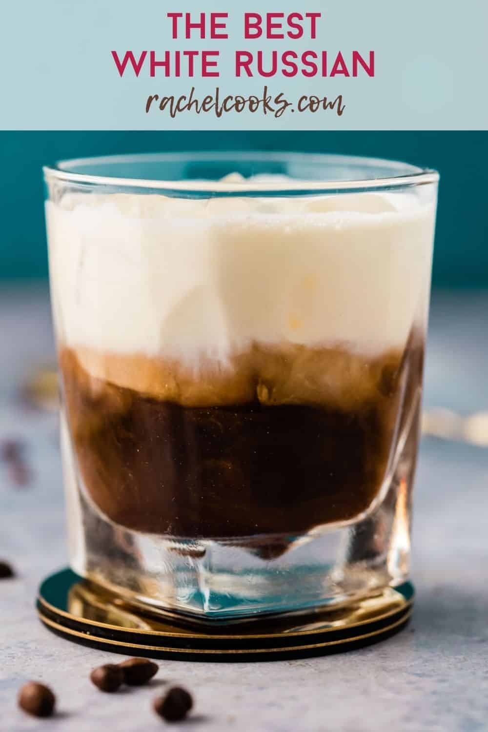 A short clear glass with a layered dark brown and white drink. Text overlay reads "the best white russian, rachelcooks.com"
