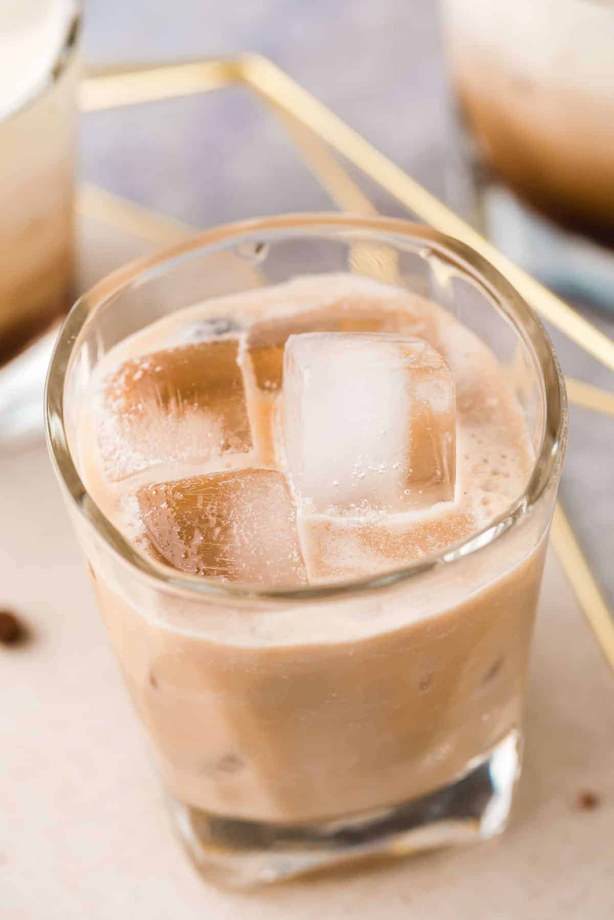 Light brown drink on ice.