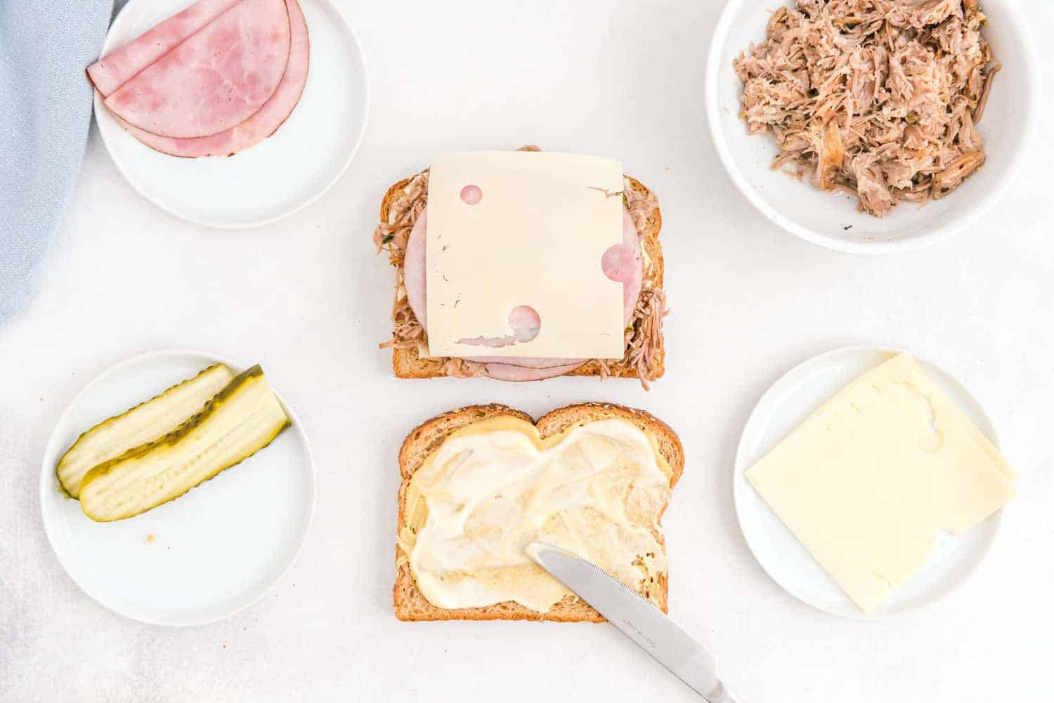 Sandwich being made with swiss cheese.