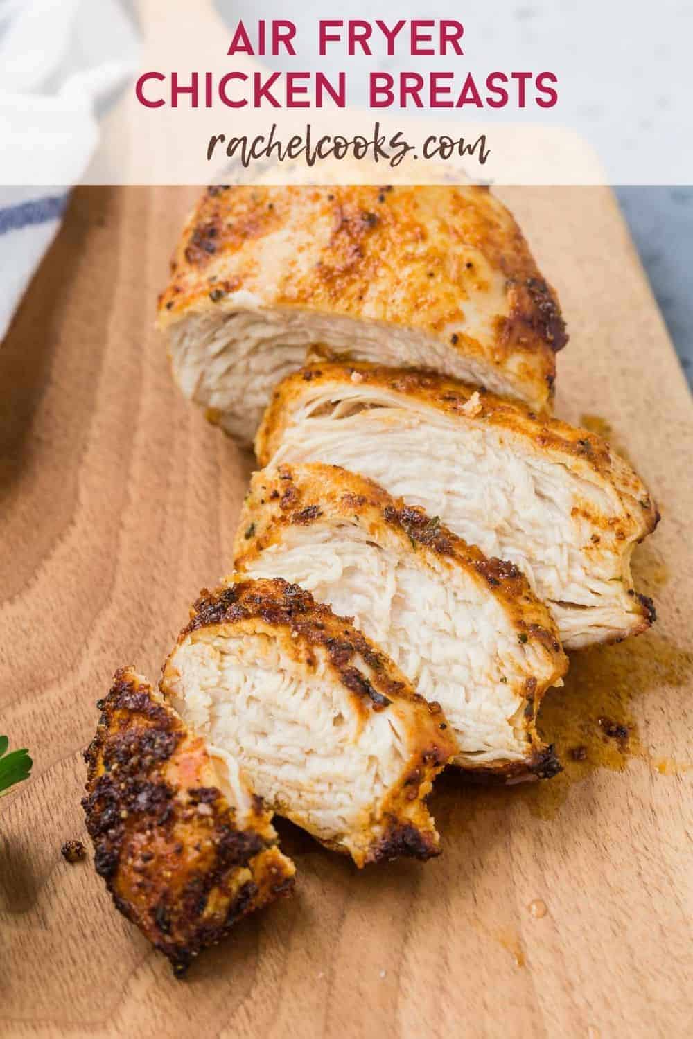 Cut chicken on a cutting board, text overlay reads "air fryer chicken breasts, rachelcooks.com"