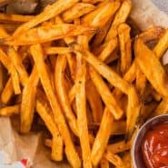 Overhead view of fries, text overlay reads "air fryer sweet potato fries, rachelcooks.com"