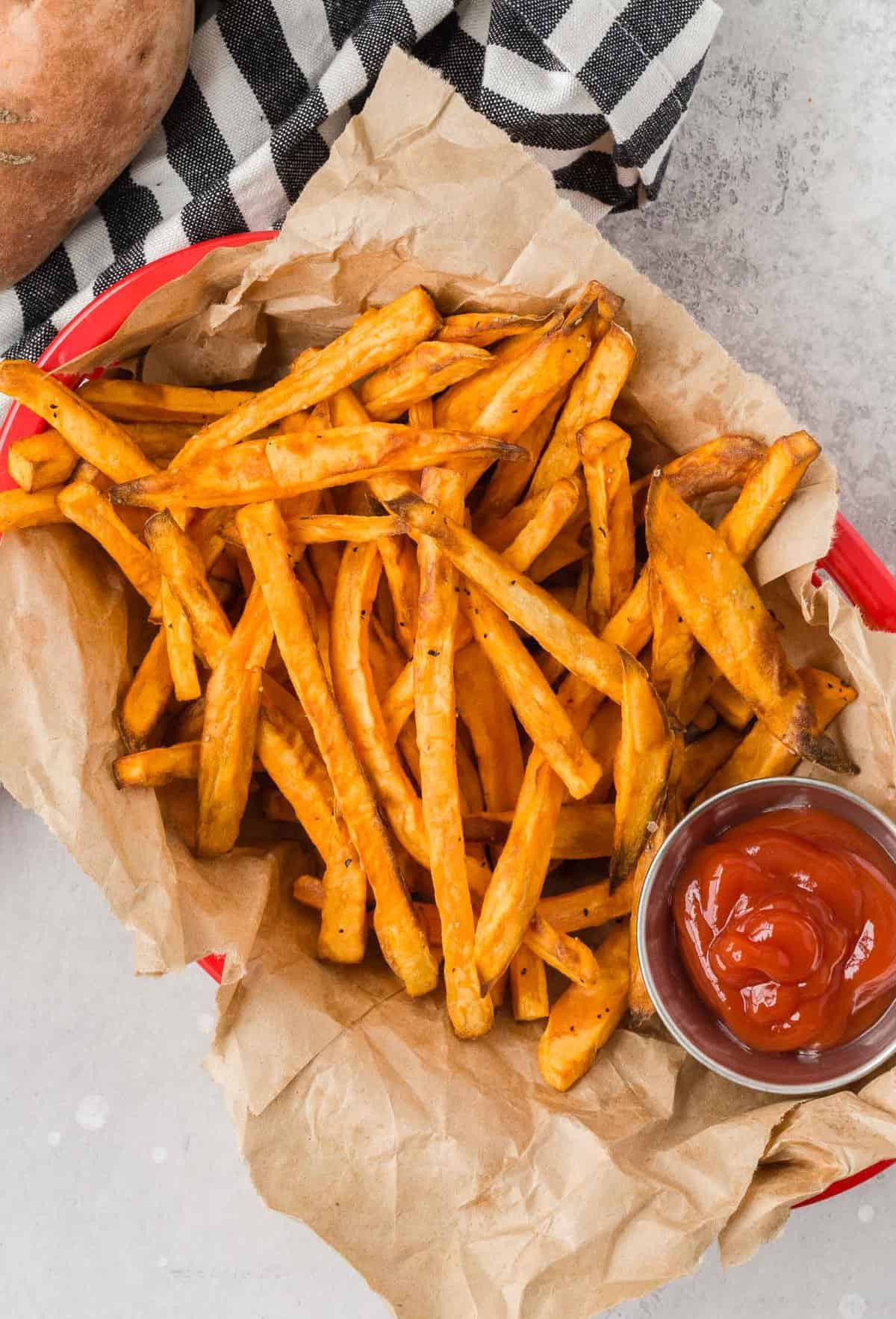 Overhead view of thin sweet potato fries in a basket.