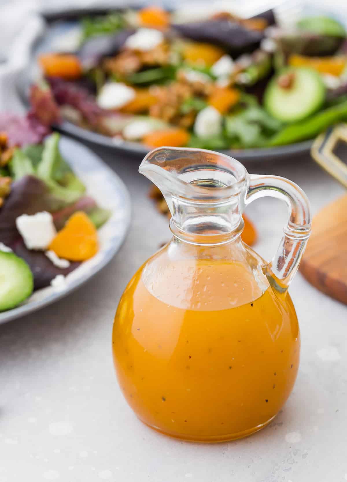 Apricot salad dressing in a small glass pitcher.