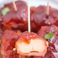 Close up of an appetizer on a toothpick, text overlay reads "the best bacon wrapped water chestnuts"