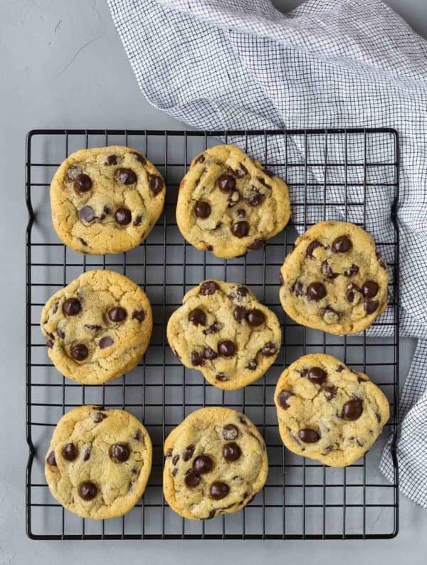 Overhead view of 8 chocolate chip cookies on a cooling rack.