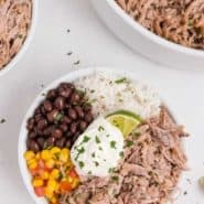 Burrito bowl with pork, beans, and rice, text overlay reads "crockpot cuban pork, rachelcooks.com"