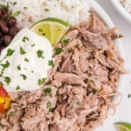 Burrito bowl with pork, beans, and rice, text overlay reads "crockpot cuban pork, rachelcooks.com"