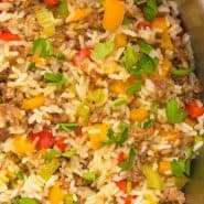 Close up of sausage and rice, text overlay reads "one pan sausage, rice, and peppers, rachelcooks.com"