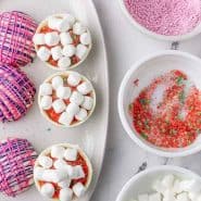 Overhead view of hot cocoa bombs being assembled, text overlay reads "pop rocks hot cocoa bombs, rachelcooks.com"