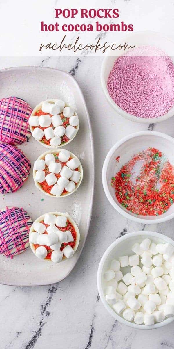 Overhead view of hot cocoa bombs being assembled, text overlay reads "pop rocks hot cocoa bombs, rachelcooks.com"