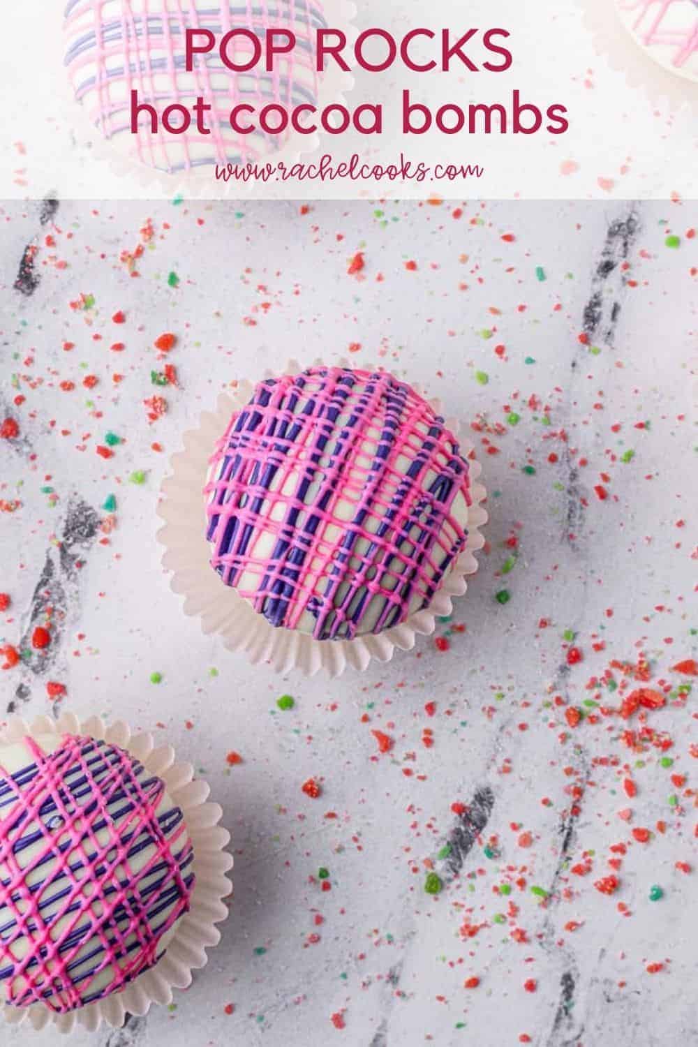 Overhead view of a hot cocoa bomb, text overlay reads "pop rocks hot cocoa bombs, rachelcooks.com"