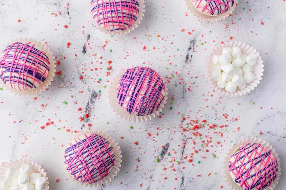 Decorated hot chocolate bombs, with pop rocks and marshmallows.