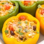 A stuffed pepper in a pan, text overlay reads "southwestern stuffed bell peppers with quinoa, rachelcooks.com"