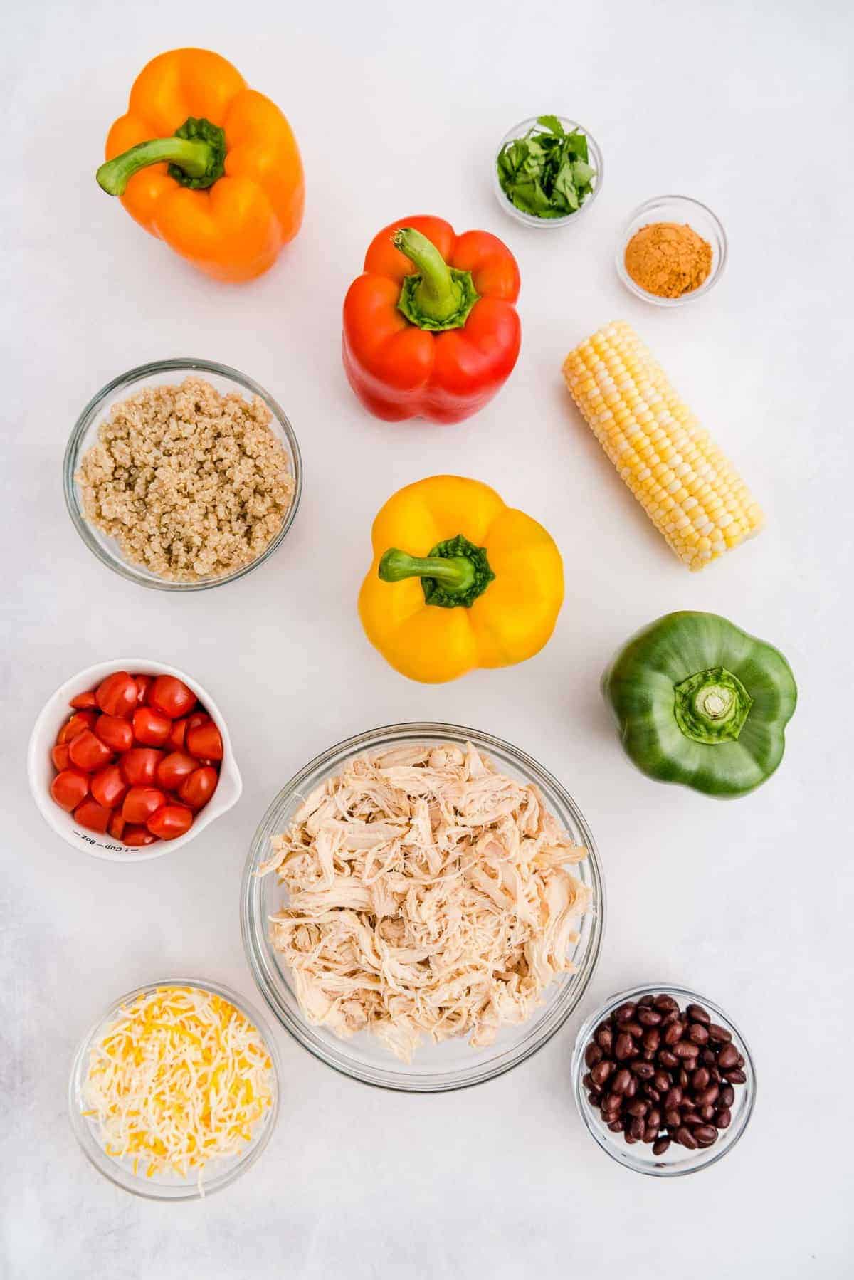 Overhead view of ingredients needed to make stuffed peppers: peppers, chicken, beans, and more.