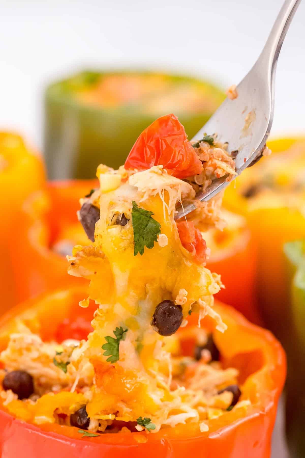 Close-up of a fork pulling filling out of a pepper.