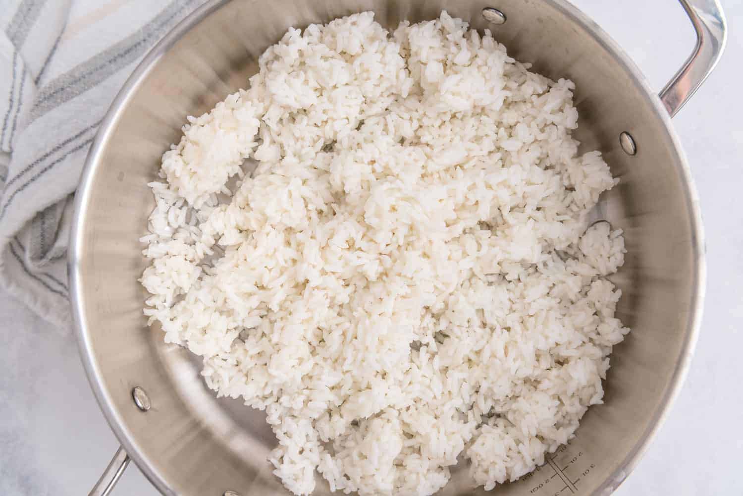 White rice in a stainless steel skillet.