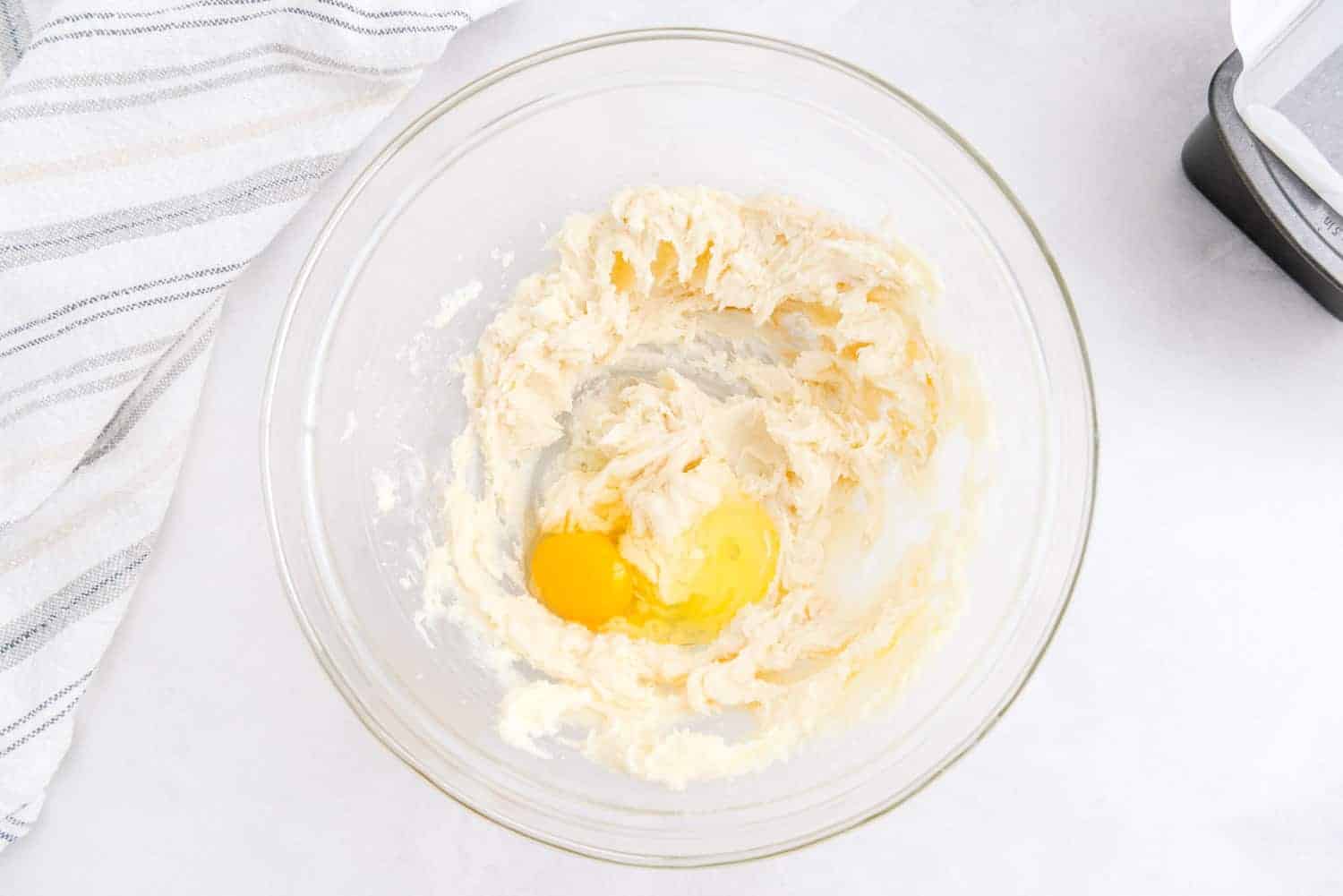 Egg added to butter and sugar.