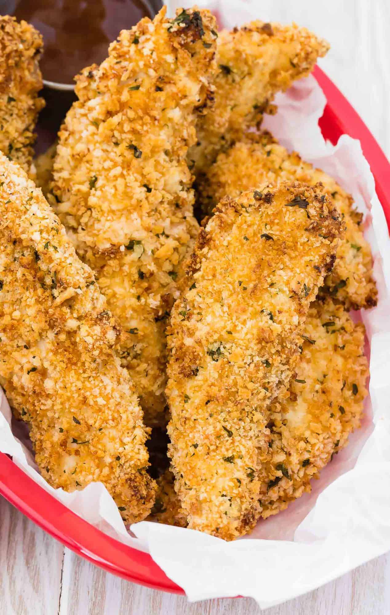 Close up of basket full of cooked chicken tenders.