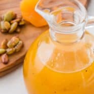 Bright orange salad dressing in a jar, text overlay reads "easy apricot vinaigrette dressing, rachelcooks.com"