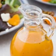 Bright orange salad dressing in a jar, text overlay reads "easy apricot vinaigrette dressing, rachelcooks.com"