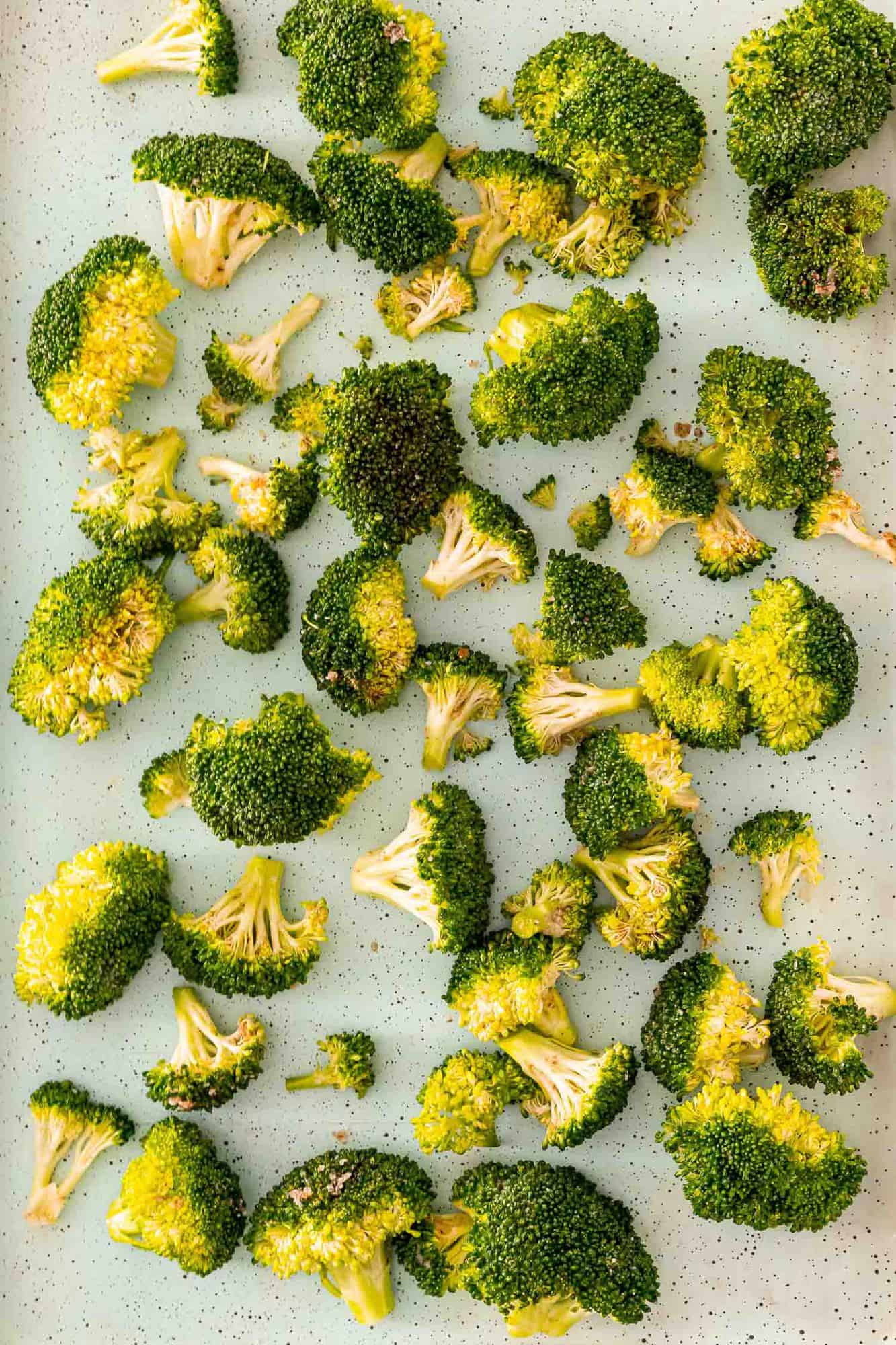 Uncooked broccoli on a sheet pan.