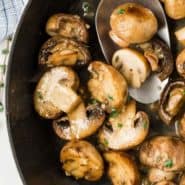 Cooked mushrooms in a pan, text overlay reads "sauteed mushrooms with white wine, rachelcooks.com"