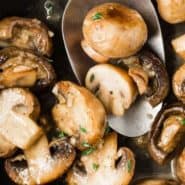 Cooked mushrooms in a pan, text overlay reads "sauteed mushrooms with white wine, rachelcooks.com"